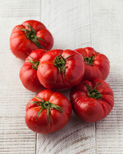 Ripe Fragrant Tomatoes On A White Wooden Background. Seasonal Vegetables.