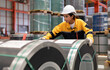 © Nassorn - Female industrial engineer in white helmet and safety jacket work in heavy metal engineering factory. Latin inspector woman inspecting production material in metalwork manufacturing facility, portrait