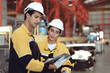 © Nassorn - Industrial engineer and Latino woman colleague in safety helmets examining production in heavy metal engineering factory. Hispanic inspector inspecting metalwork in manufacturing warehouse facility.