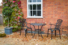 UK Hard Landscaped Garden In Autumn With Garden Patio Furniture