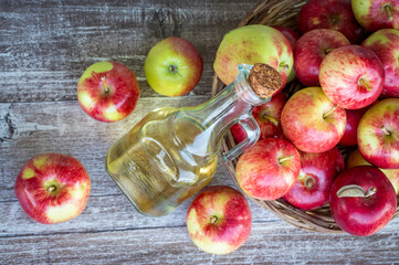 Red tasty apples and apple cider vinegar