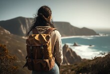 A Woman With A Backpack Looking At The Ocean From A Cliff, Concept Travel, Concept Tourism, Concept Autumn