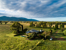 Australian Farm Landscape With Farmers House Among Green Paddocks