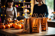 Asian-American parents preparing Halloween goodie bags for their child's school party; illustration with empty space for text 