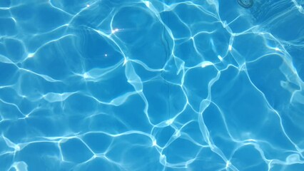 Poster - Blue water in the pool with sun glare.
