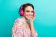 Profile portrait of cheerful gorgeous lady toothy smile hand touch headphones chilling isolated on turquoise color background