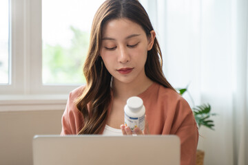 Wall Mural - Mindful Health Habits: Engaging in Informed Wellness - A Person Deliberates Supplement Information Before Consumption for Optimal Nutritional Awareness and Personal Well-being.