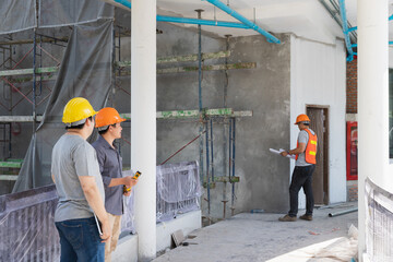 Wall Mural - Team of architect working together in building construction site. They discussing about new startup project. Engineer, foreman, Architect, contractor and worker in building construction site.