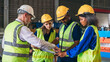 © NewSaetiew - Team engineers and foreman stack hand and shake hands to show success at factory machines. Worker industry join hand for collaboration.