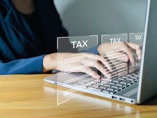 Business people use computers to fill out annual tax information. Calculating tax rates and preparing business financial budgets Effective tax deduction planning ideas for individuals and companies.