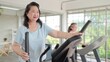 © M Stocker - Asian elderly women exercising on the machine in living room at home. Mature woman enjoy doing exercising on treadmill for well being slimming weight. Elderly lifestyle concept