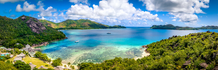 Praslin Seychelles tropical island with withe beaches and palm trees. Aerial view of tropical paradise bay with granite stones and turquoise crystal clear waters of Indian Ocean