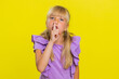 © Andrii Iemelianenko - Shh be quiet please. Preteen child girl kid presses index finger to lips makes silence hush gesture sign do not tells gossip secret. Little cute children isolated alone on studio yellow background