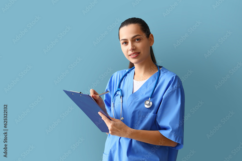 Female doctor writing in clipboard on blue background