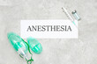 Paper with word ANESTHESIA, oxygen masks, syringe and ampule on grunge background