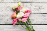 Fototapeta Kwiaty - Beautiful pink eustoma flowers on white wooden background