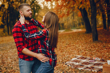 Wall Mural - Elegant couple spend time in a autumn park