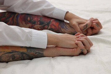 Wall Mural - passionate couple having sex on bed, closeup of hands