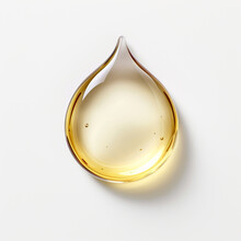 Drop Of Golden Oil Isolated On White Background