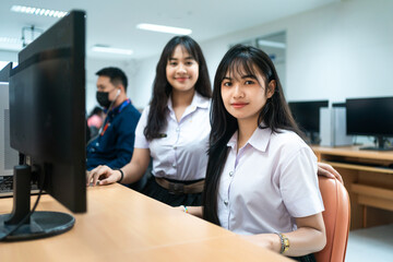Asian girls students studying computer subject in computer classroom