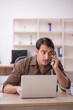 © Elnur - Young attractive employee sitting in the office
