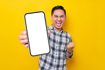 smiling handsome young asian man wearing a white checkered shirt showing a screen mobile phone for a