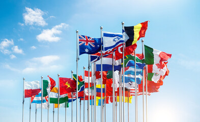 set of flags fluttering in the wind against blue sky background