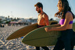© Dusan Petkovic - A happy couple on vacation walking on beach and going surfing.