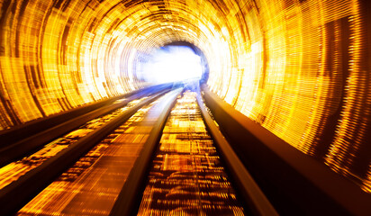 Train moving fast in tunnel with blurred motion