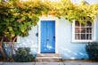 Ai generative.  Blue front door of traditional style home.  A front entrance of a home with a blue door.