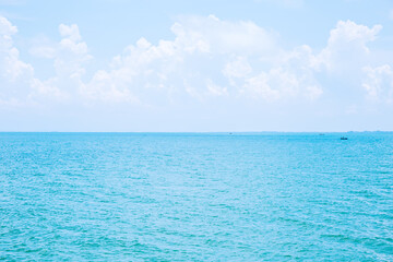 Wall Mural - sea or ocean calm water with blue sky and white clouds.