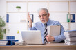 © Elnur - Old male employee working in the office