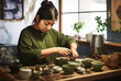 © Maureen - Woman preparing matcha tea with all the equipment