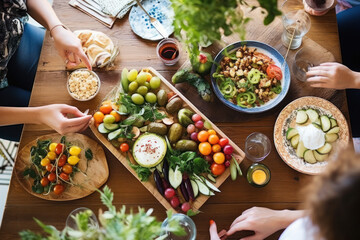 Wall Mural - High angle view of fresh meal on table. Women are eating healthy food. They are with Mediterranean platter. 