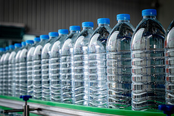 Spring Water factory - Water bottling line for processing pure water into small bottles. Selective focus.