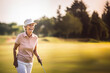 © Kalim - AI generated image of senior female on golf