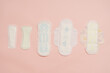 Different feminine sanitary napkins (sanitary pads) on pink background
