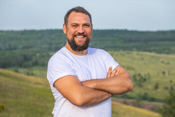 Portrait of a middle-aged brunette man with a thick beard