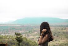 Young Girl Enjoying Beauty Of Nature Looking At Mountain In Saputara, Gujarat. Adventure Travel In Monsoon. Woman Stands With Background Of Forest And Mountains.