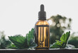 Wild organic Urtica dioica, common nettle, stinging nettle tincture in small brown glass bottle outdoors with fresh plant leaves. Lifestyle shot, bokeh background with copy space.