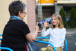 © Andrii Zastrozhnov - A deaf child communicates in sign language with a teacher on the playground.