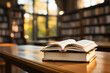 Open book on a wooden table with blurred library background eyelevel view
