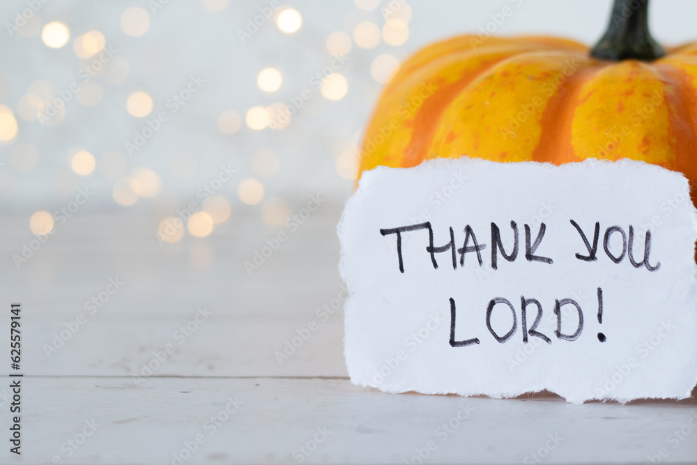 Thank You LORD, handwritten message on note and autumn pumpkin fruit on ...