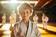 © Keitma - Happy European boy at Judo or Karate training lesson looking at camera