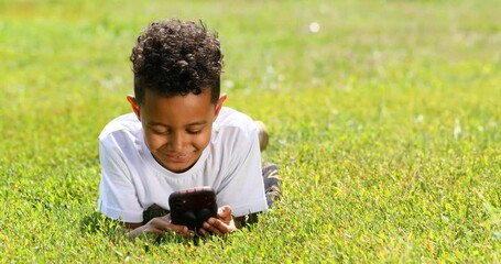 Wall Mural - Little boy resting lying on the lawn