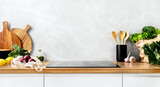 Fototapeta Lawenda - Contemporary kitchen concept or culinary background. Front view of a kitchen counter top with some utensils and culinary ingredients. Huge empty space for a text above.