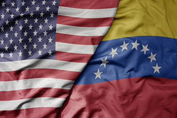 Wall Mural - big waving colorful flag of united states of america and national flag of venezuela .