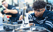© nuttawutnuy - Mechanical engineering team working in robotic technology lap for research and develop for manufacturing automation and robotics.