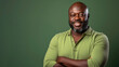 © Robert Kneschke - Muscular African man in 40s, bald, green polo shirt