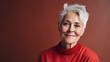 © Robert Kneschke - Caucasian woman in 60s, short grey hair, red color theme